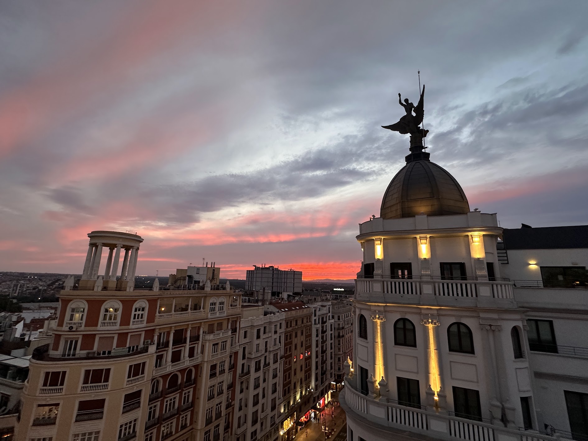 The sun sets over downtown Madrid, near Gran Vía.